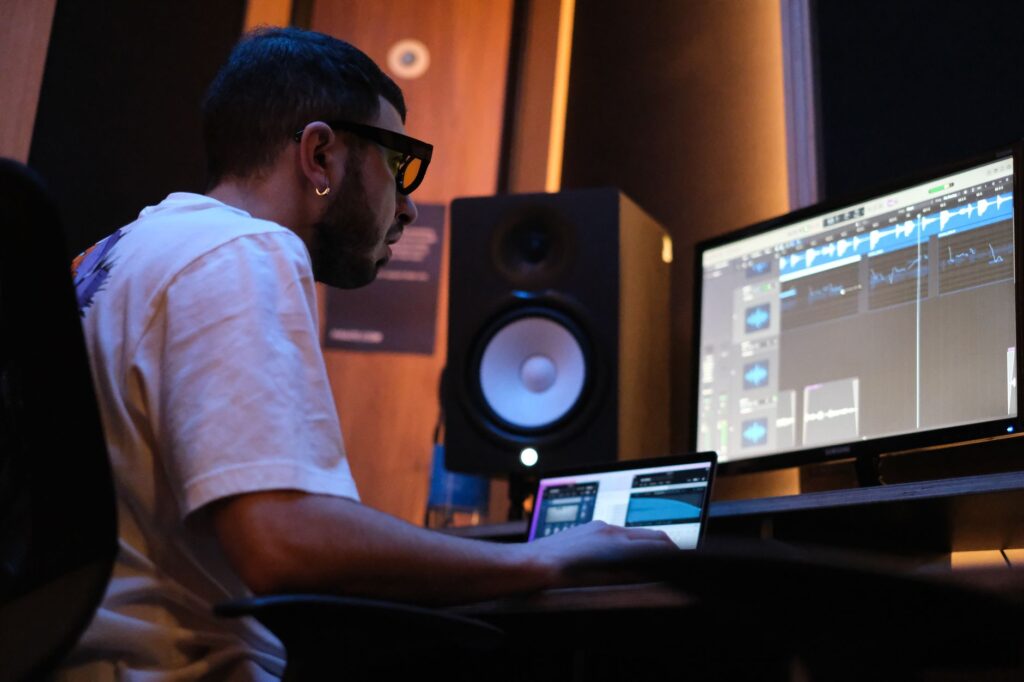 The bittersweet goodbye that saved a broken brotherhood โ cinematic photo of a music producer sitting on a couch in a recording studio looking emotional
