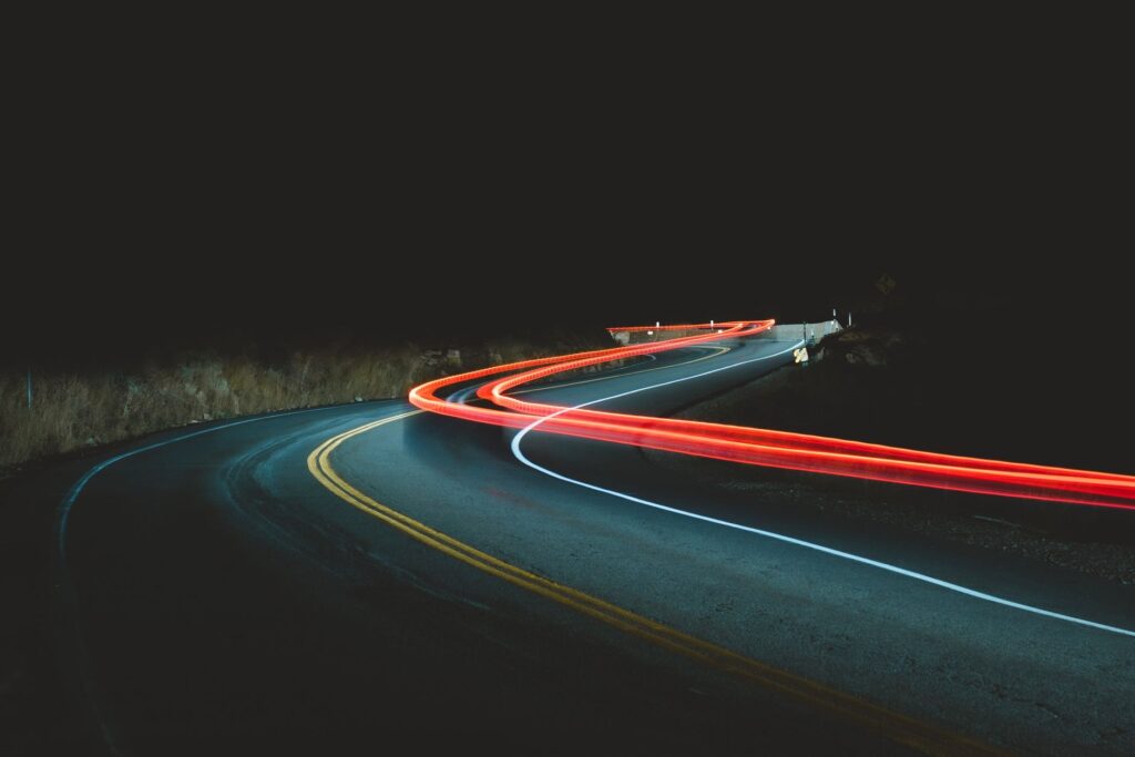 The melody that saved lives on Italy's highways — dark empty highway winding road night headlights