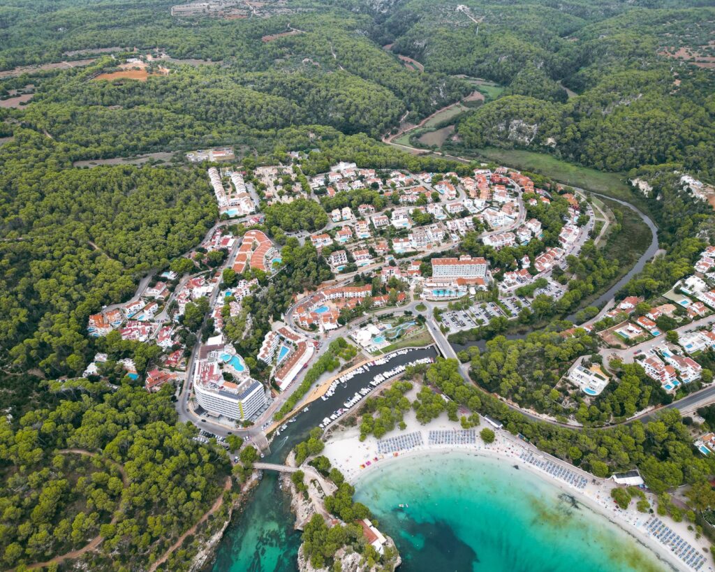 Ibiza license freeze could save the island from its own hype โ aerial view of Ibiza coastline sunset