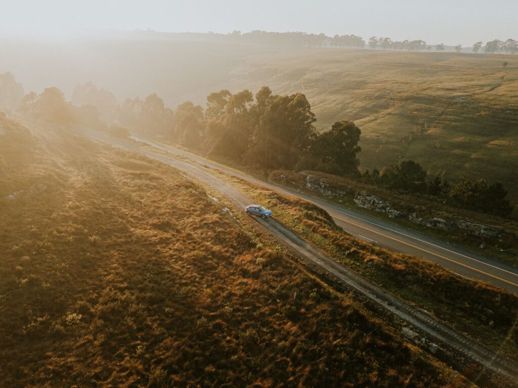 The silent dawn that birthed Tony Overstar's Unchained — car driving at dawn empty road morning light