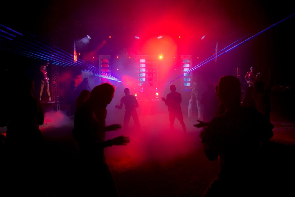 The four-minute rebellion of Eric Prydz's Opus — dark warehouse rave laser lights crowd silhouette