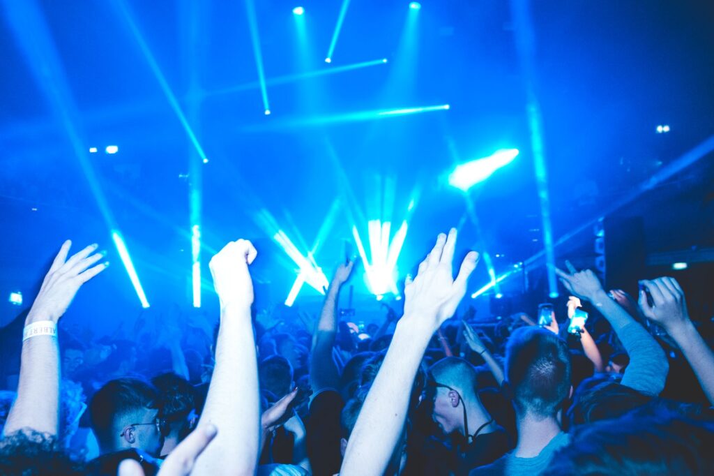 The day we traded our hearts for a mainstage anthem — concert crowd hands in the air blue lights