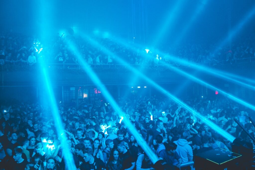 Ibiza license freeze could save the island from its own hype โ dark moody warehouse rave crowd strobe lights