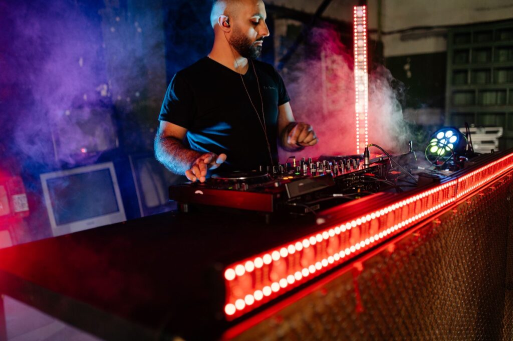 How Surge is turning fans into the festival industry's last hope — dj performing in smoke filled warehouse club