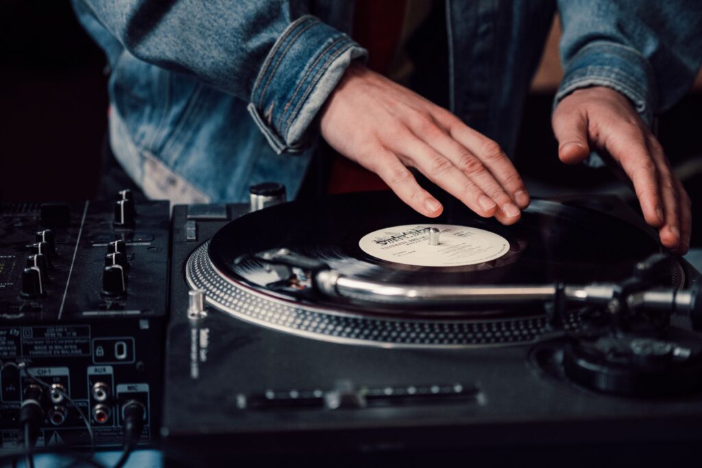 Why Armin van Buuren is pressing his own vinyl for Ibiza — vinyl record spinning on a turntable in a dark club close up