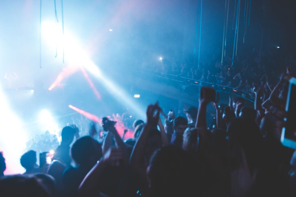 Why Gigi D'Agostino's masterpiece still defeats the algorithm — crowd hands up laser lights club rave